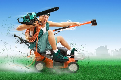 Crazy workman covered with instruments driving lawn mower